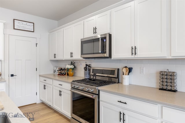 1502 Cyril Way, Belgrade, MT 59714 - kitchen with stainless steel appliances, decorative backsplash, and light countertops