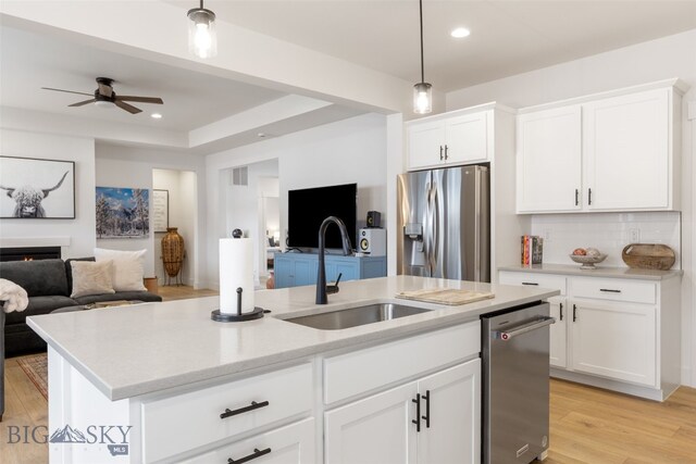 1502 Cyril Way, Belgrade, MT 59714 - kitchen featuring appliances with stainless steel finishes, a sink, open floor plan, a center island with sink, and recessed lighting