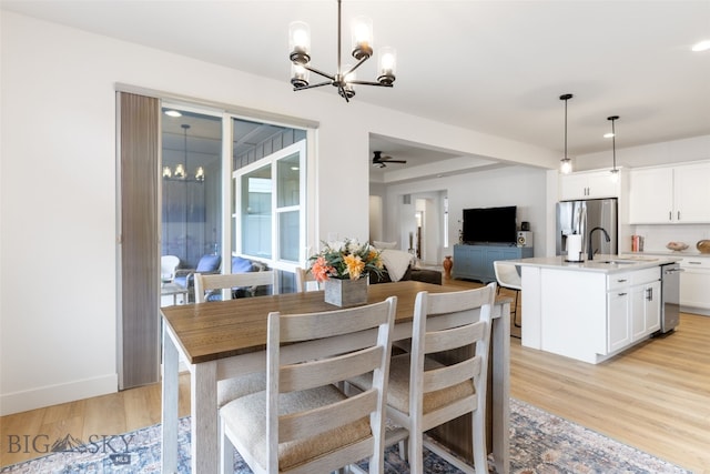 1502 Cyril Way, Belgrade, MT 59714 - dining area with a chandelier, light wood-type flooring, a ceiling fan, baseboards, and recessed lighting