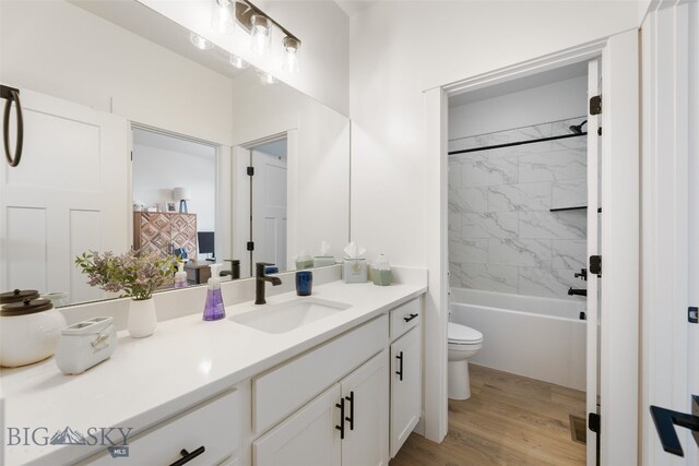 1502 Cyril Way, Belgrade, MT 59714 - bathroom featuring toilet, vanity, wood finished floors, and shower / bath combination