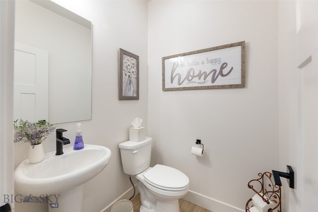 1502 Cyril Way, Belgrade, MT 59714 - bathroom featuring baseboards, a sink, and toilet