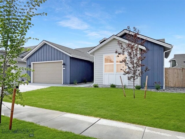 1502 Cyril Way, Belgrade, MT 59714 - view of front of property featuring board and batten siding, a garage, and driveway