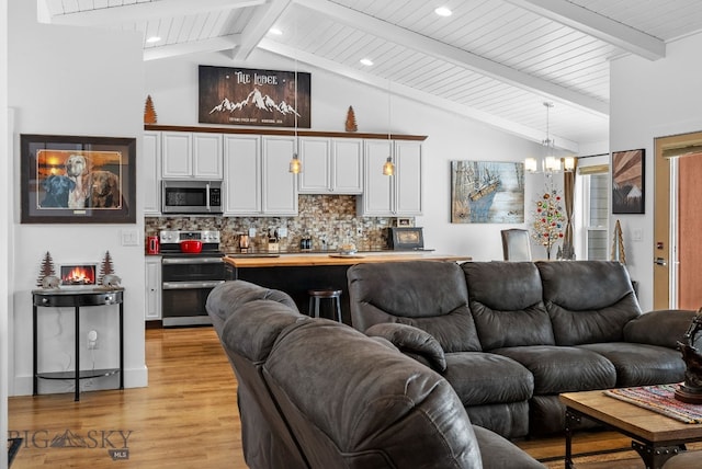 9 Blue Stem Way, Three Forks, MT 59752 - living room with a chandelier, light wood finished floors, and wooden ceiling