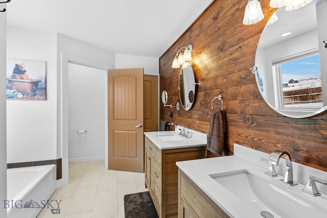 9 Blue Stem Way, Three Forks, MT 59752 - bathroom featuring two vanities, a garden tub, and tile patterned floors