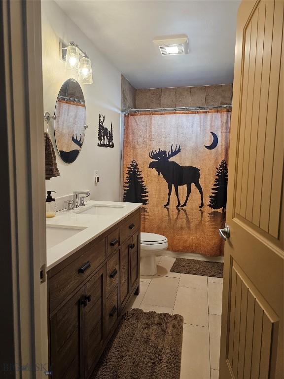 9 Blue Stem Way, Three Forks, MT 59752 - full bathroom featuring double vanity, toilet, and a shower with curtain