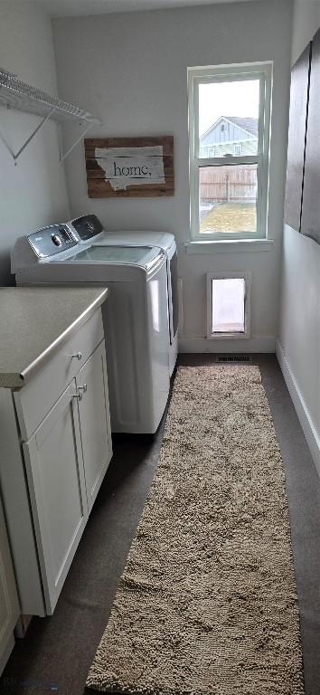 9 Blue Stem Way, Three Forks, MT 59752 - washroom with washing machine and dryer, cabinet space, baseboards, and dark carpet
