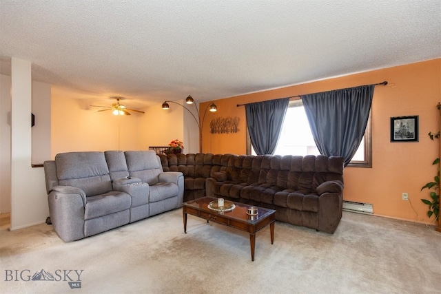 living room with carpet floors, a textured ceiling, a baseboard heating unit, and a ceiling fan