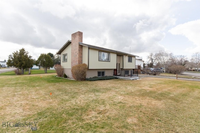view of front of house featuring a front yard and a chimney