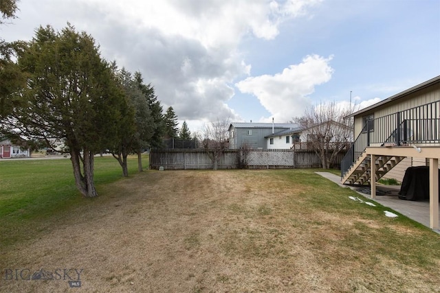 view of yard with stairway and fence
