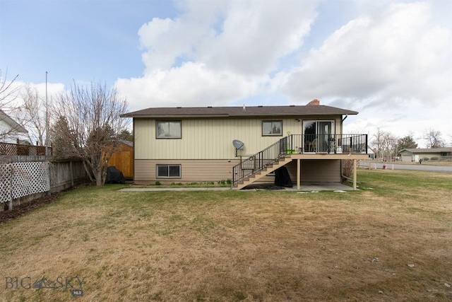 rear view of house with a lawn, stairs, fence, and a wooden deck