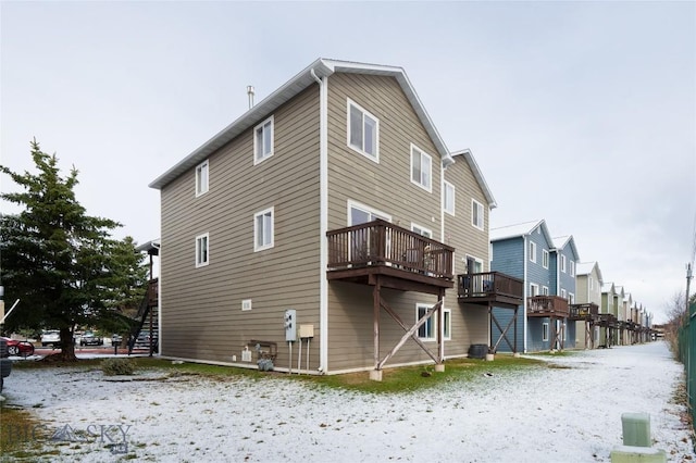1719 W Kagy, Bozeman, MT 59715 - snow covered rear of property with stairs and a wooden deck