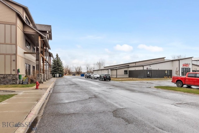 67 Village Dr Unit 4A, Belgrade, MT 59714 - view of asphalt road featuring curbs and sidewalks