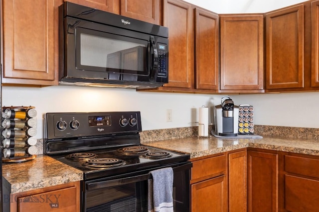 67 Village Dr Unit 4A, Belgrade, MT 59714 - kitchen with black appliances and brown cabinets