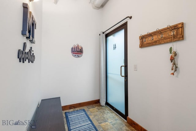 67 Village Dr Unit 4A, Belgrade, MT 59714 - entryway with baseboards and stone finish floors