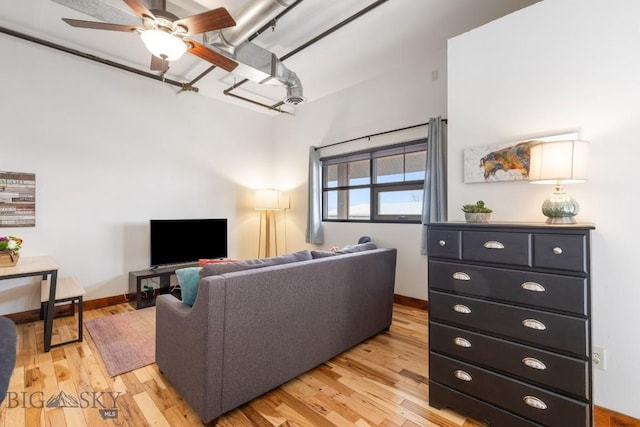 67 Village Dr Unit 4A, Belgrade, MT 59714 - living room with light wood finished floors, a ceiling fan, and baseboards