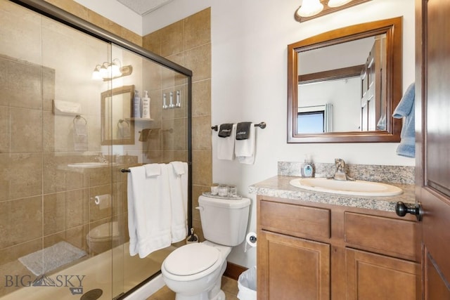 67 Village Dr Unit 4A, Belgrade, MT 59714 - bathroom featuring vanity, a stall shower, and toilet