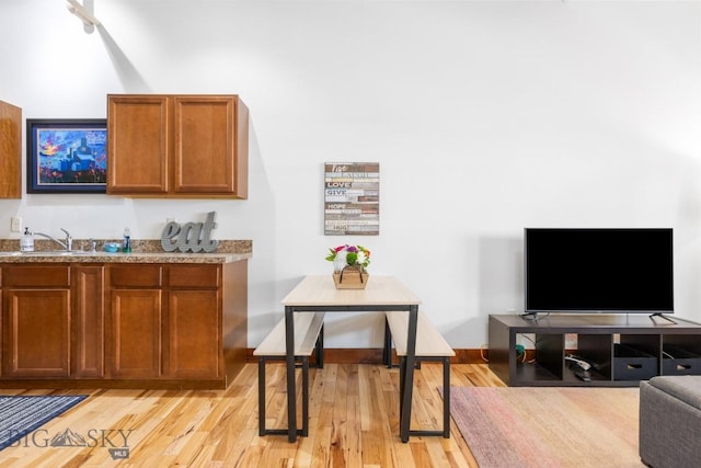 67 Village Dr Unit 4A, Belgrade, MT 59714 - bar area featuring a sink and light wood-style floors