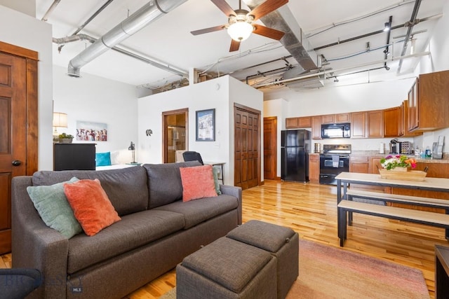 67 Village Dr Unit 4A, Belgrade, MT 59714 - living area with light wood-style flooring, a high ceiling, and ceiling fan