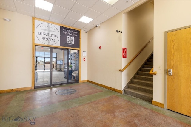 67 Village Dr Unit 4A, Belgrade, MT 59714 - lobby featuring a paneled ceiling, stairs, and a security system