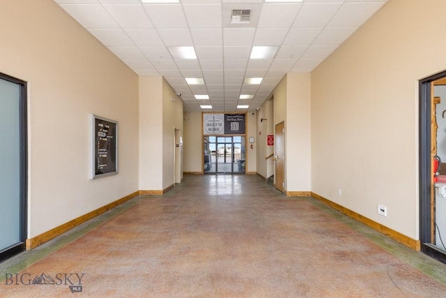 67 Village Dr Unit 4A, Belgrade, MT 59714 - unfurnished room with baseboards, finished concrete floors, and a paneled ceiling
