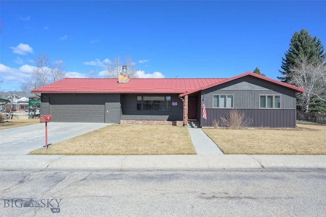 single story home featuring driveway, metal roof, a chimney, and an attached garage