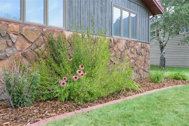 view of side of home with stone siding
