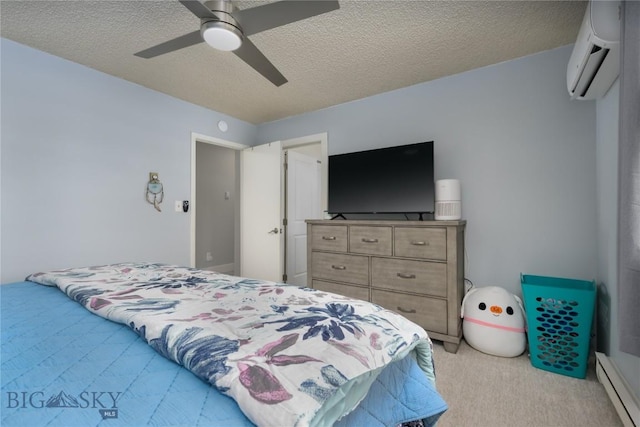 bedroom with a textured ceiling, a ceiling fan, a baseboard heating unit, a wall unit AC, and light colored carpet