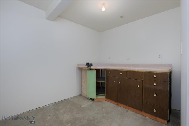 interior space with concrete floors and beam ceiling