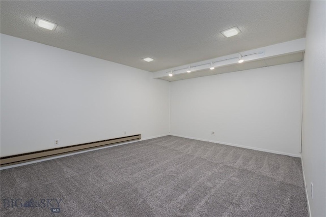 unfurnished room featuring carpet flooring, a textured ceiling, track lighting, a baseboard radiator, and baseboards