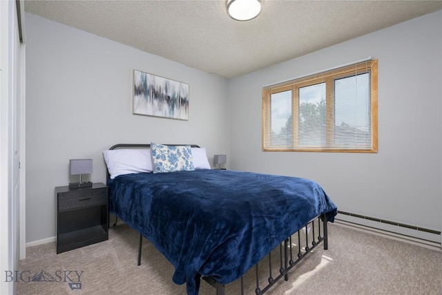 carpeted bedroom featuring a textured ceiling, baseboards, and baseboard heating