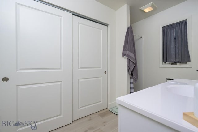 laundry room with light wood-type flooring