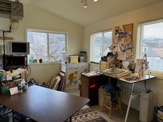 office featuring lofted ceiling and radiator heating unit