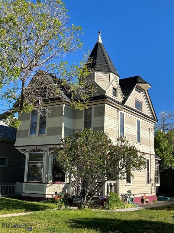 view of side of property with a lawn