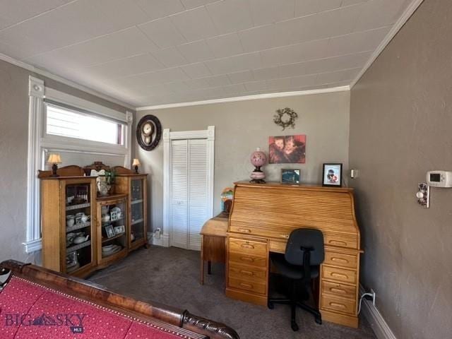 carpeted office space featuring baseboards and crown molding
