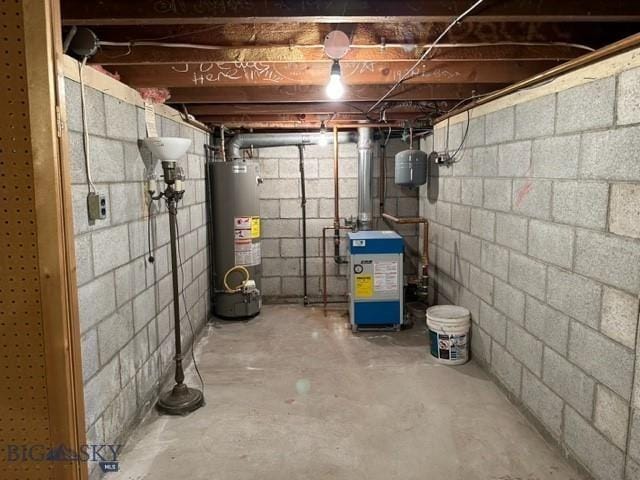 unfinished below grade area with a heating unit and gas water heater