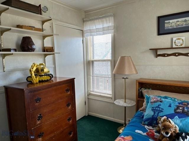 bedroom with crown molding and dark carpet