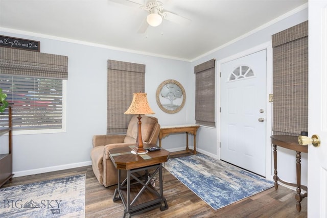 entryway with ceiling fan, baseboards, ornamental molding, and wood finished floors