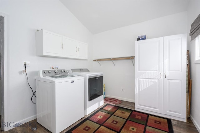 laundry room featuring cabinet space, baseboards, washing machine and dryer, and wood finished floors