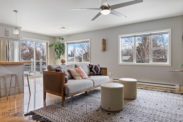 211 N Yellowstone Ave, Bozeman, MT 59718 - living room featuring a baseboard radiator, light wood-type flooring, and ceiling fan