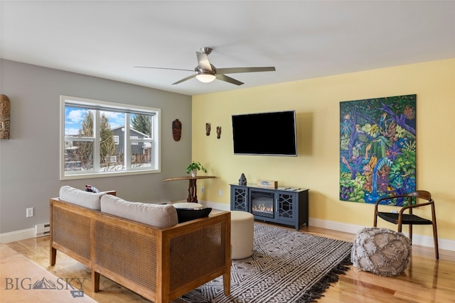 211 N Yellowstone Ave, Bozeman, MT 59718 - living room with a baseboard radiator, wood finished floors, a ceiling fan, and baseboards