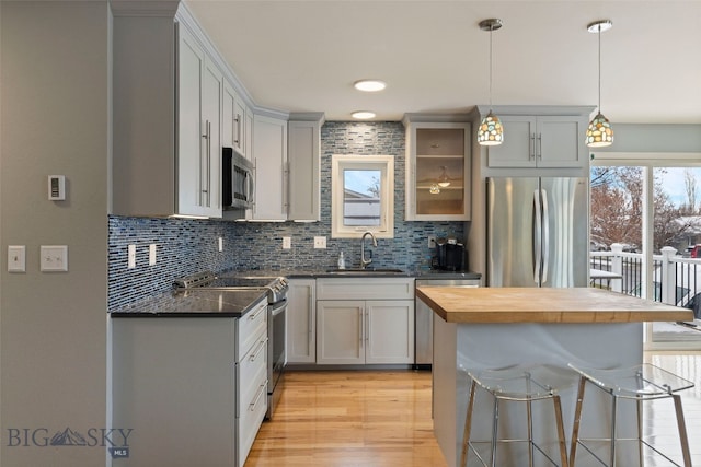 211 N Yellowstone Ave, Bozeman, MT 59718 - kitchen with stainless steel appliances, a sink, tasteful backsplash, and butcher block counters