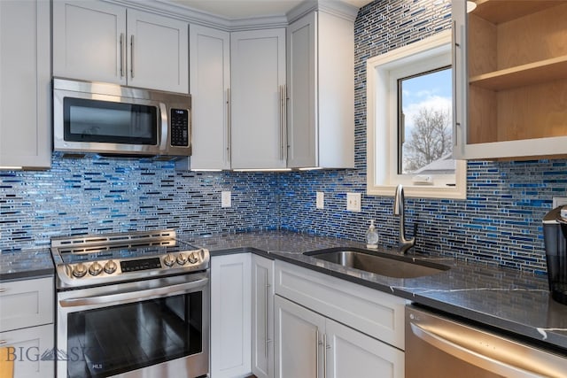 211 N Yellowstone Ave, Bozeman, MT 59718 - kitchen with appliances with stainless steel finishes, a sink, backsplash, and dark stone counters