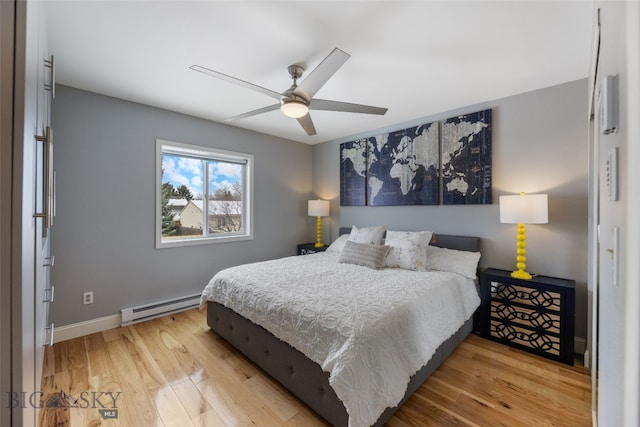 211 N Yellowstone Ave, Bozeman, MT 59718 - bedroom featuring baseboard heating, light wood-style floors, baseboards, and a ceiling fan