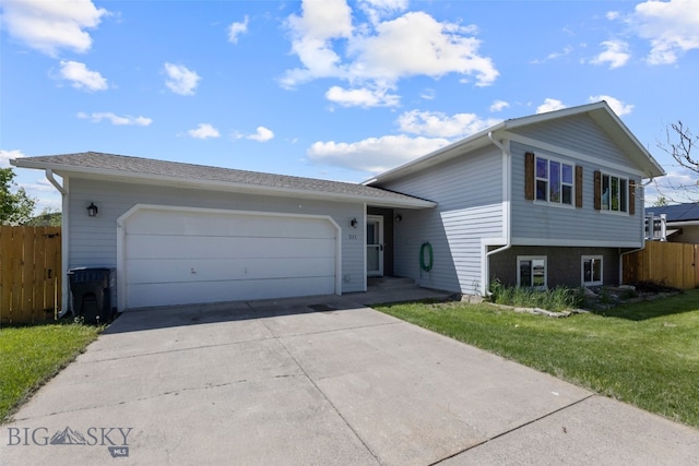 211 N Yellowstone Ave, Bozeman, MT 59718 - split level home with concrete driveway and an attached garage