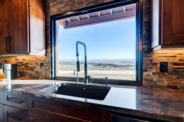 251 Fawn Mdw, Manhattan, MT 59741 - kitchen featuring a sink, backsplash, dark countertops, and dark brown cabinetry