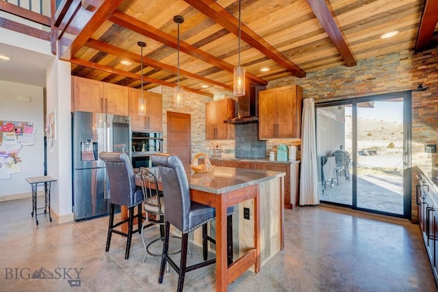 251 Fawn Mdw, Manhattan, MT 59741 - kitchen with stainless steel appliances, wood ceiling with exposed beams, concrete flooring, wall chimney range hood, and tasteful backsplash