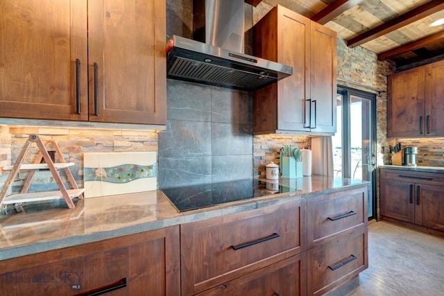 251 Fawn Mdw, Manhattan, MT 59741 - kitchen featuring wall chimney range hood, black electric stovetop, backsplash, and wood ceiling with exposed beams