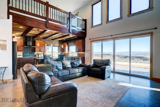 251 Fawn Mdw, Manhattan, MT 59741 - living area featuring baseboards, finished concrete floors, a towering ceiling, and wood ceiling with exposed beams