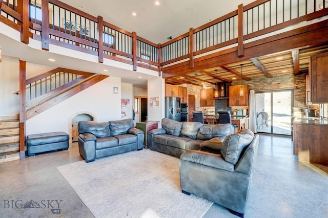 251 Fawn Mdw, Manhattan, MT 59741 - living room featuring a towering ceiling, stairs, beam ceiling, and recessed lighting