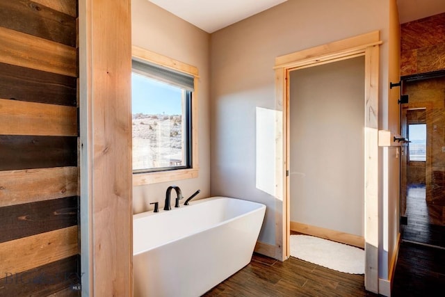 251 Fawn Mdw, Manhattan, MT 59741 - full bathroom featuring a freestanding tub and wood finished floors